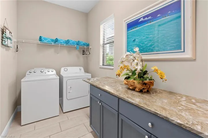 Washroom with washer and dryer and cabinet space