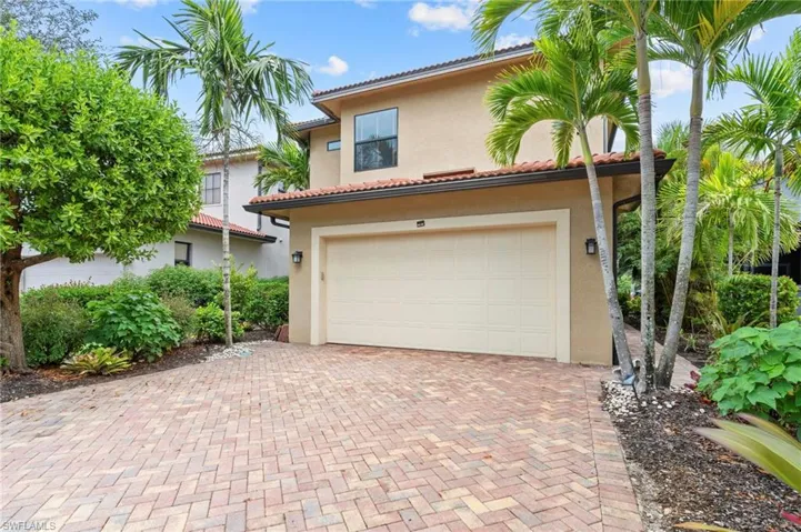 Mediterranean / spanish home with stucco siding, an attached garage, decorative driveway, and a tiled roof