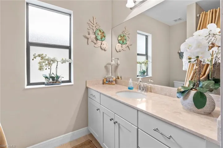Bathroom featuring vanity and baseboards
