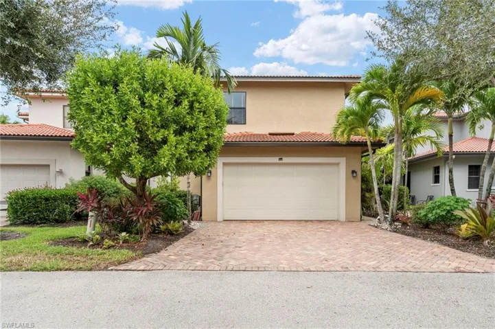 Mediterranean / spanish home with decorative driveway, stucco siding, and an attached garage