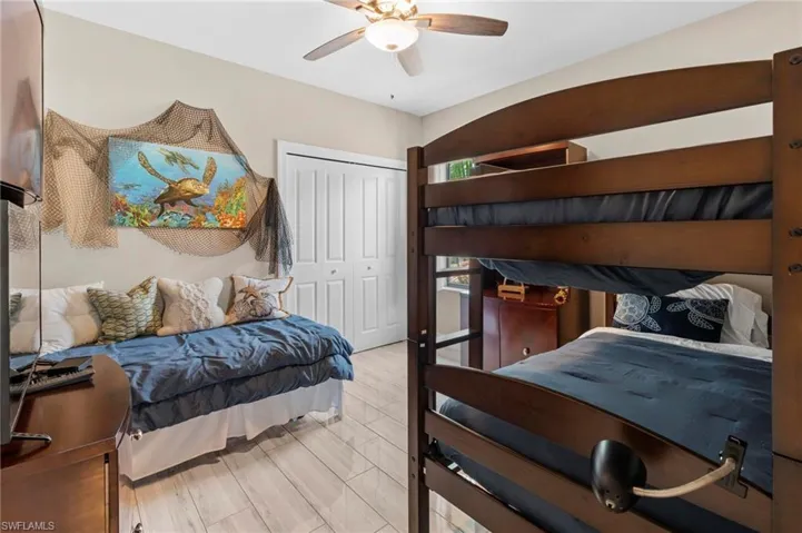 Bedroom featuring a closet, light wood-style flooring, and a ceiling fan