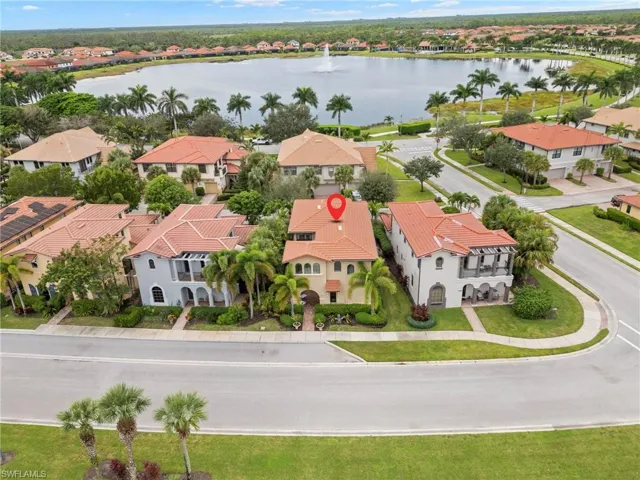 Aerial view of residential area featuring a nearby body of water