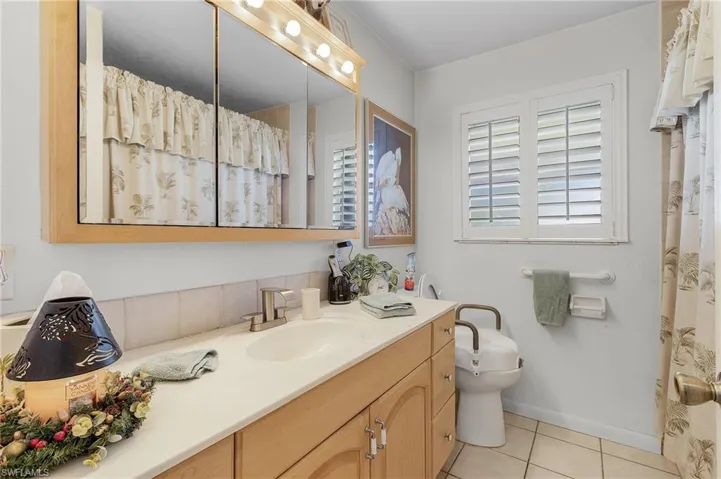 Bathroom with vanity, toilet, and tile patterned floors and tub and shower combo located on the east side of home between the 2 guest bedrooms