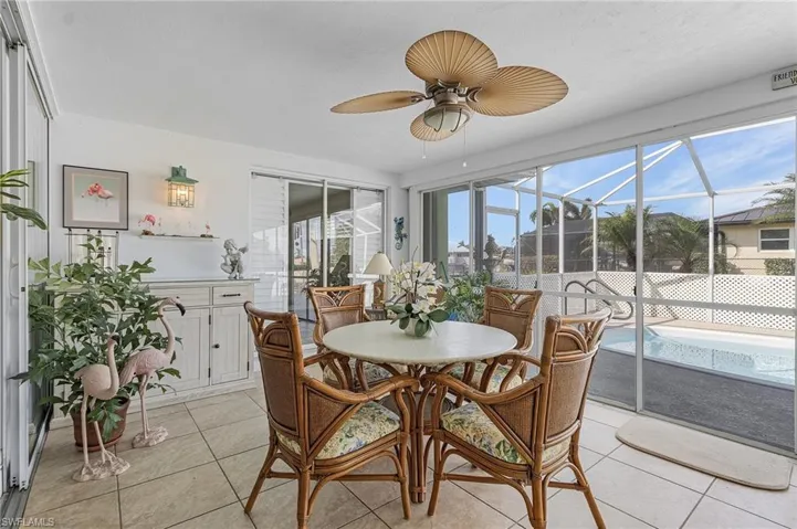 Sunroom featuring ceiling fan and plenty of natural light, sliders to the Primary bedroom suite