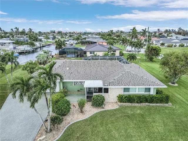 Birds eye view of property with a water view