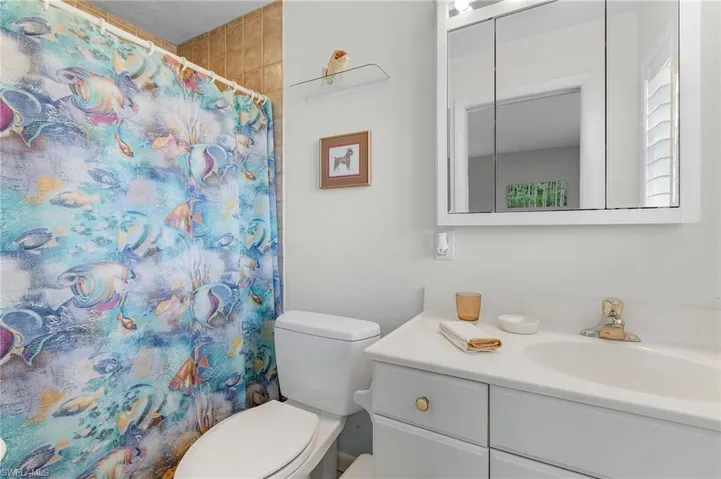Bathroom with vanity, toilet, and a walkin shower