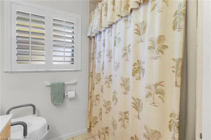 Bathroom with vanity, tub/shower combo, toilet, and tile patterned floors