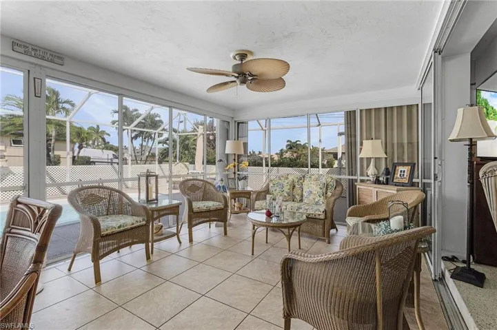 Sunroom featuring ceiling fan