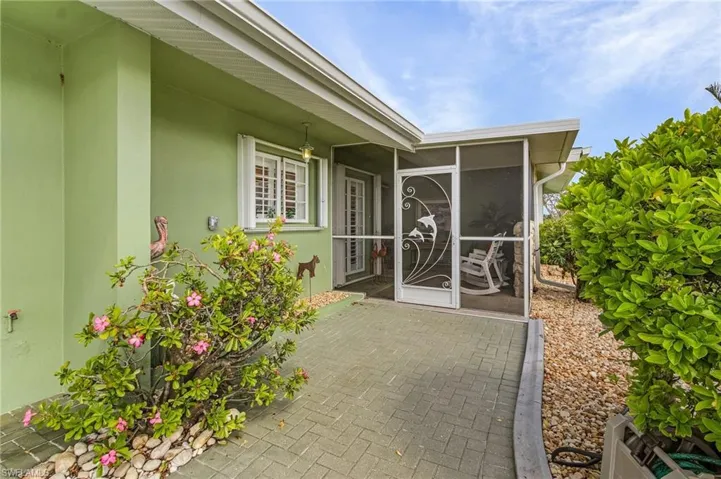 Entrance to property with wide entry with inviting screened front porch
