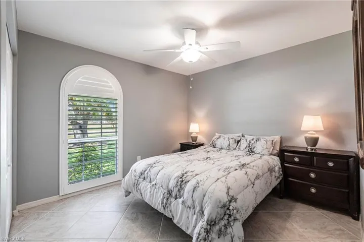 Tiled Guest Bedroom with ceiling fan