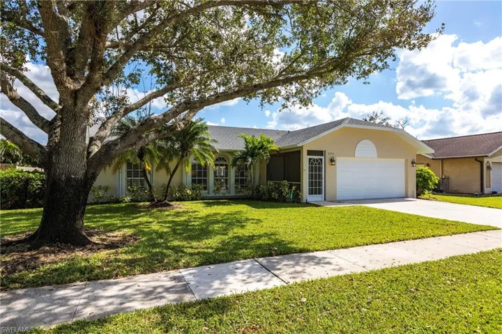 Ranch-style home featuring a 2 car garage and a front lawn