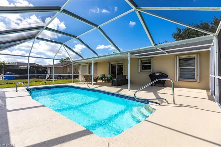 View of pool with a lanai, and an outdoor hangout area