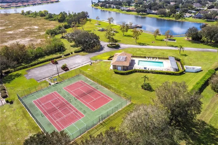 Birds eye view of Community Amenities featuring tennis courts and a water view