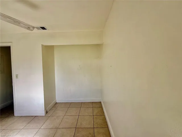 This room features tile flooring, an integrated wall niche, and a ceiling fan