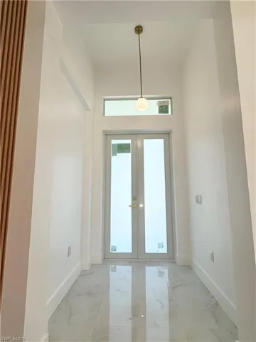 Doorway featuring french doors and marble tiled flooring