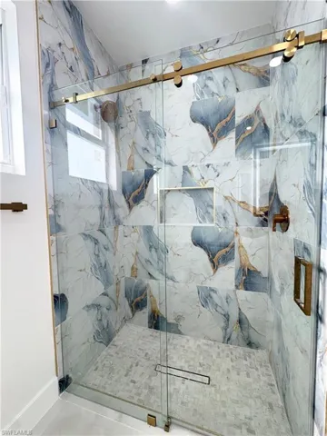 Full bathroom featuring a marble finish shower