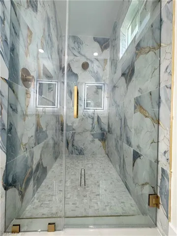 Bathroom with a marble finish shower