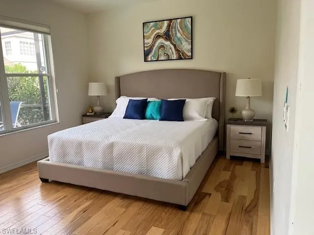 Bedroom featuring light wood finished floors and baseboards