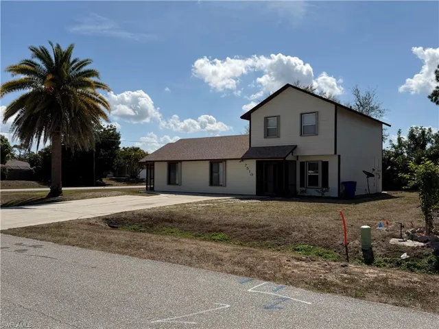 Traditional home featuring a front yard
