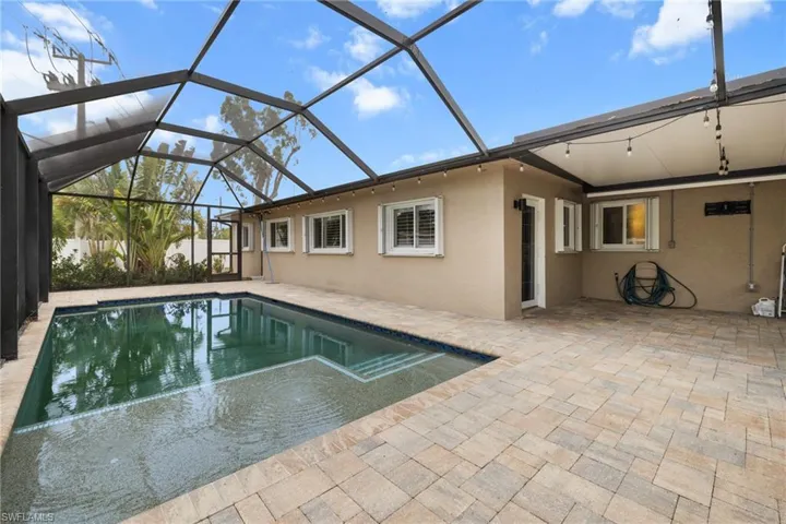 Swimming pool with a patio and a lanai