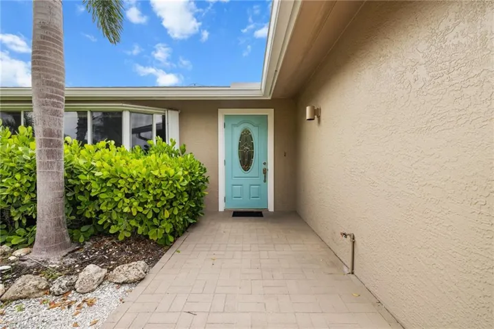 Entrance to property with stucco siding