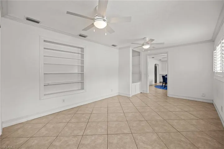 Full bath with tile walls, toilet, a stall shower, a wainscoted wall, and vanity
