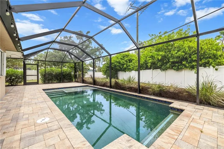 View of swimming pool with a patio, a fenced backyard, and a lanai