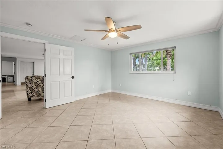 Bathroom with wainscoting, toilet, vanity, tub / shower combination, and wood finished floors