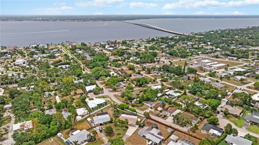 Aerial overview of property's location with a notable bridge, a large body of water, and nearby suburban area