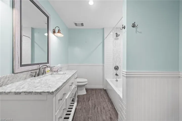 Unfurnished bedroom with ornamental molding, baseboards, a closet, ceiling fan, and light tile patterned flooring