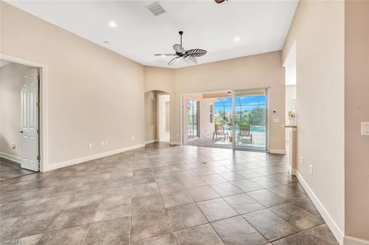 Tiled empty room with ceiling fan