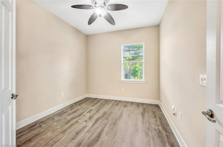 Spare room featuring hardwood / wood-style floors and ceiling fan