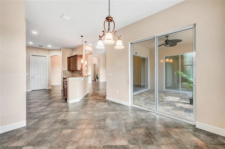 Unfurnished dining area featuring tile patterned flooring and ceiling fan