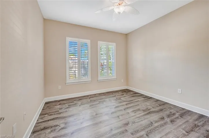Unfurnished room featuring light wood-type flooring and ceiling fan
