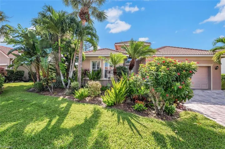 Mediterranean / spanish house with a garage and a front lawn