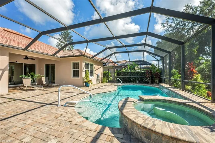 View of pool featuring a lanai, a patio area, an in ground hot tub, and ceiling fan