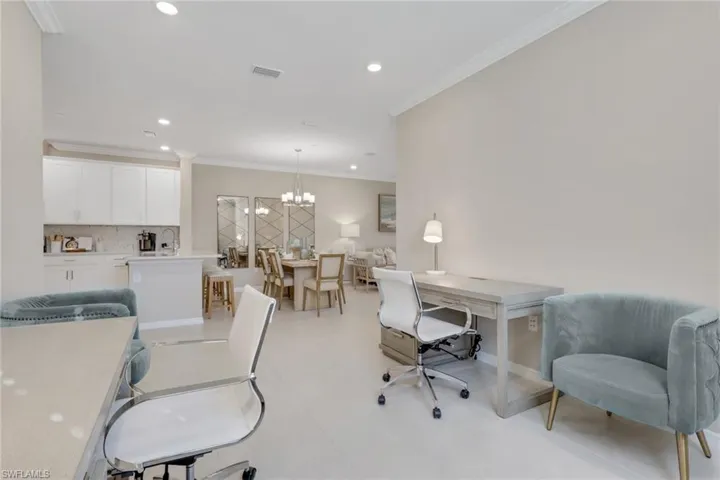 Office space with crown molding, recessed lighting, and a chandelier