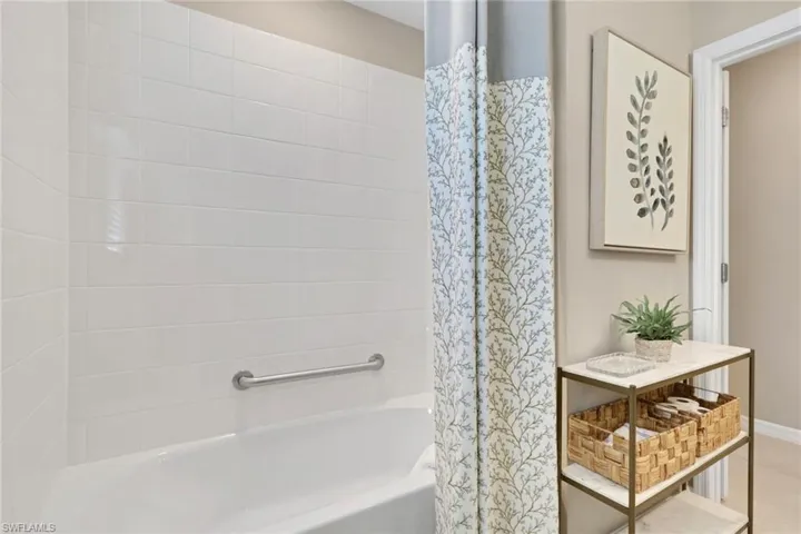 Full bath featuring shower / tub combo with curtain