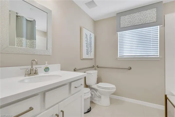 Full bathroom featuring a shower with curtain, vanity, light tile patterned flooring, and a tub to relax in