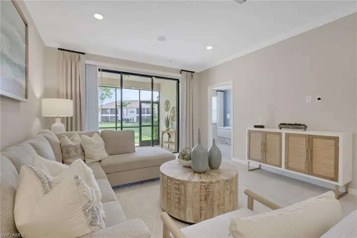 Tiled living room with recessed lighting and crown molding