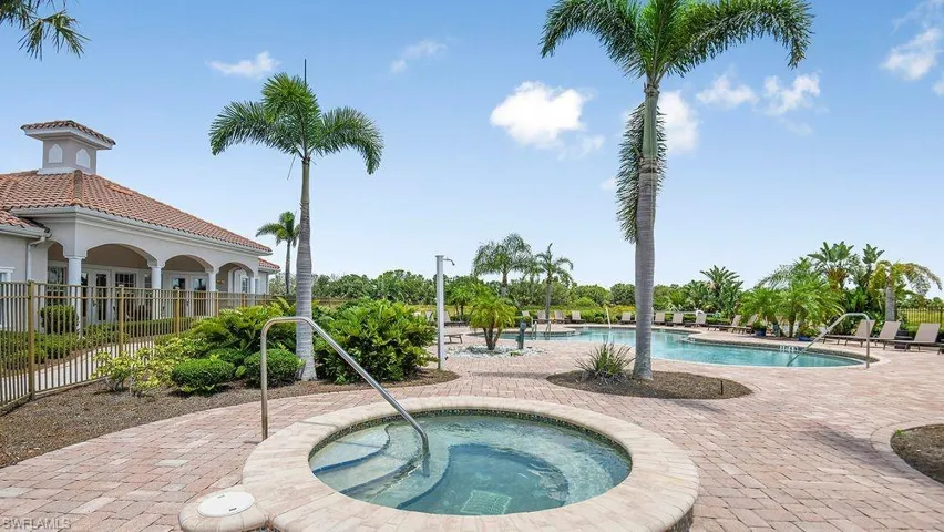 Community pool with a patio area and a community hot tub