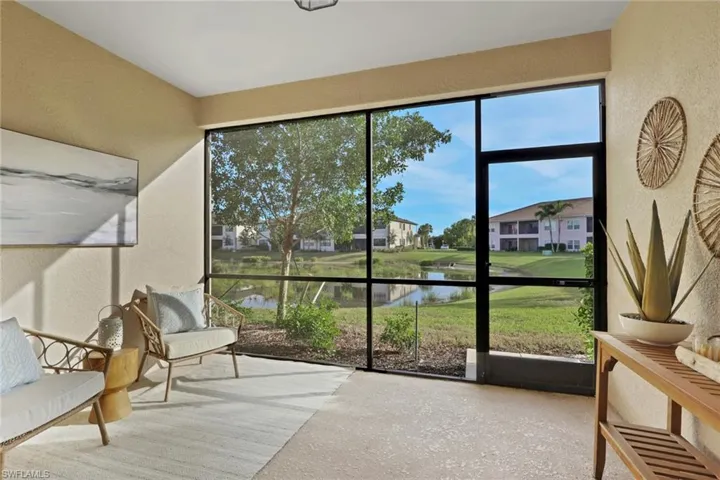 Sunroom featuring a water view