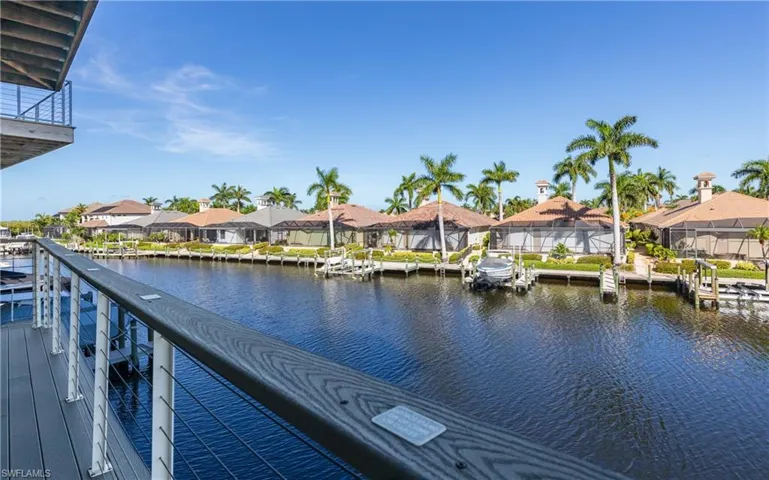 2nd-level Expansive waterfront deck featuring composite decking, cable railing, and a covered patio area off the Kitchen, Living/Dining-room.