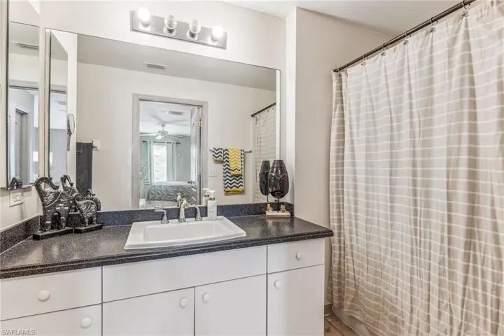 Back Bedroom with new vinyl floor, Ceiling Fan.  Overlooks backyard.