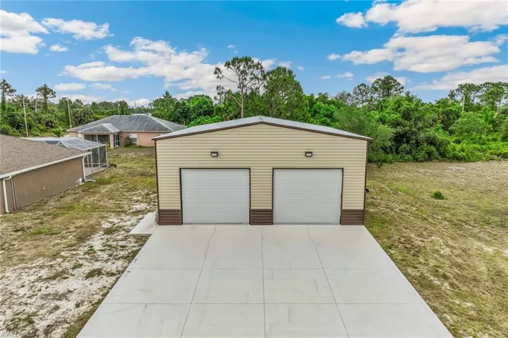 Featuring vaulted ceiling, dark tone countertops, stainless steel appliances.