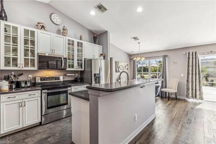Featuring ceiling fan, arched doorways, LVf floors, planter shelves.