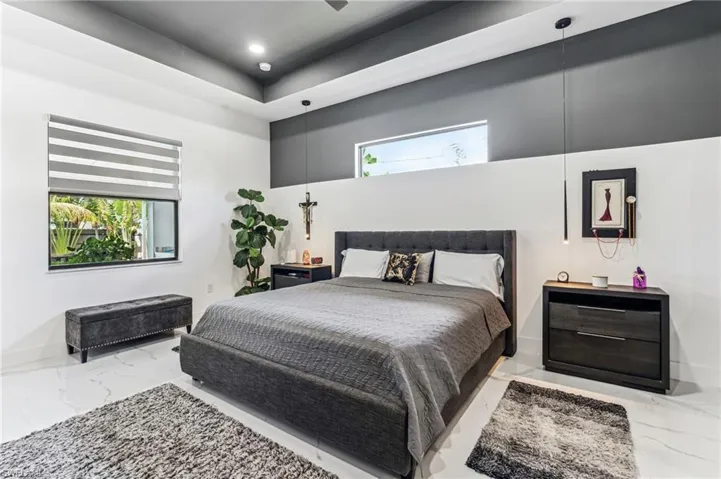 Bedroom featuring marble finish floor, baseboards, and recessed lighting