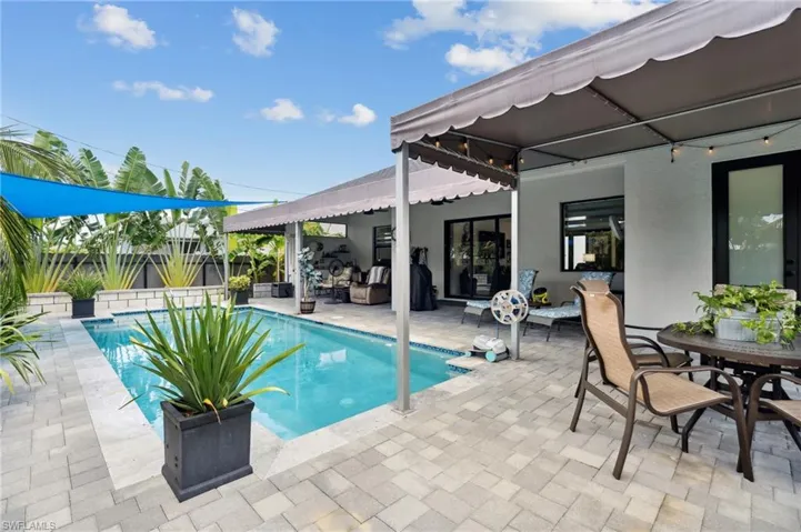 View of pool with fence, outdoor dining area, a patio, and a fenced in pool