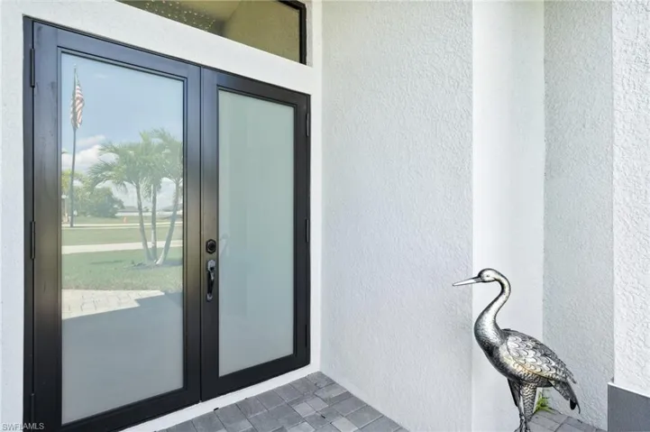 Entrance to property with stucco siding