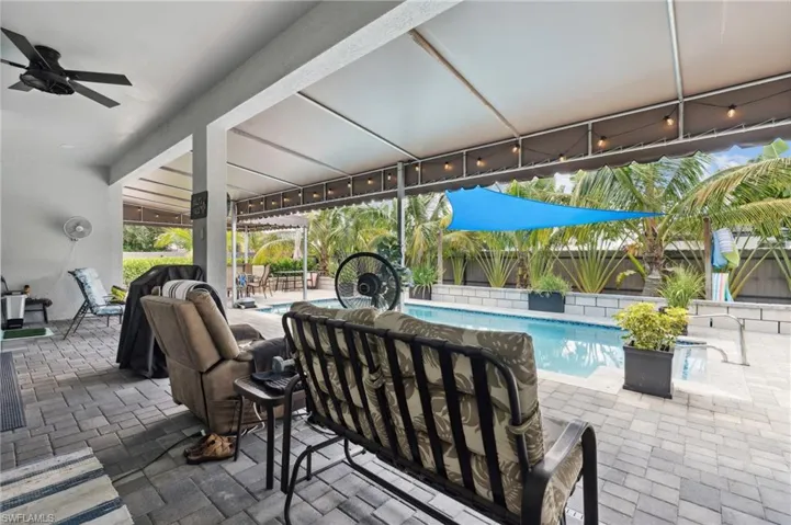 View of patio / terrace featuring ceiling fan, fence, and a fenced in pool